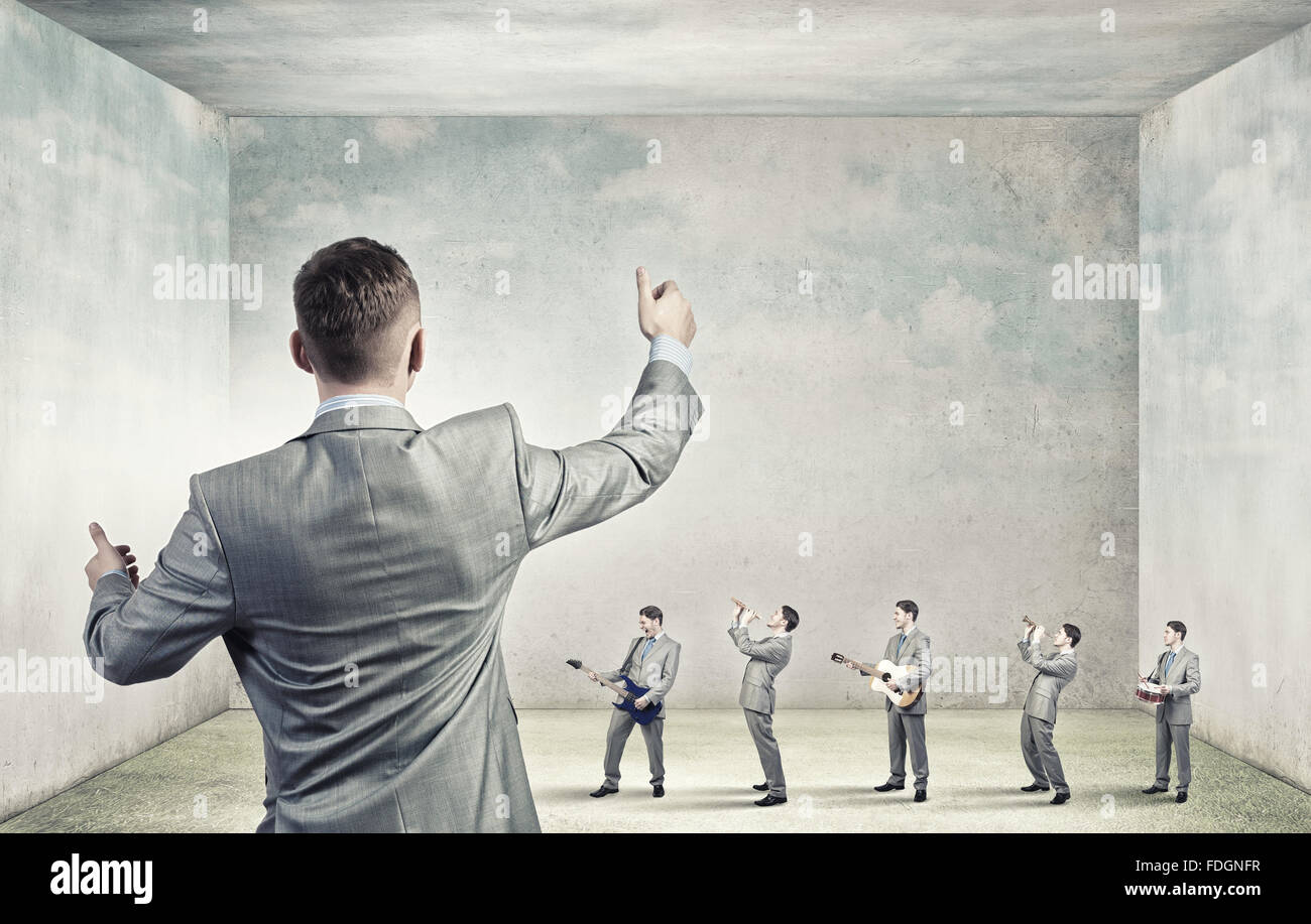 Man orchestra in suit playing different music instruments Stock Photo ...