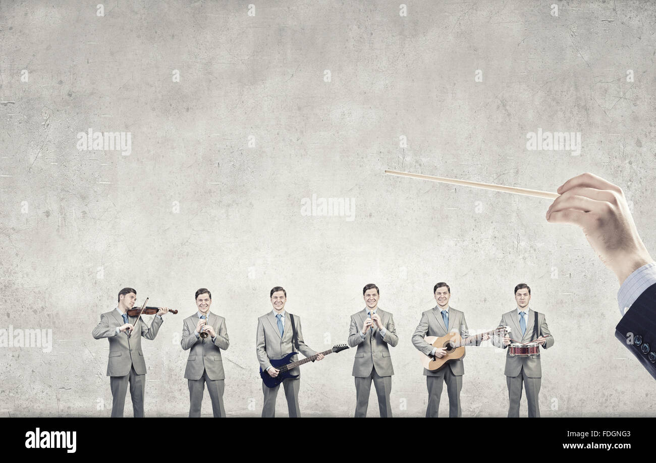 Man orchestra in suit playing different music instruments Stock Photo ...