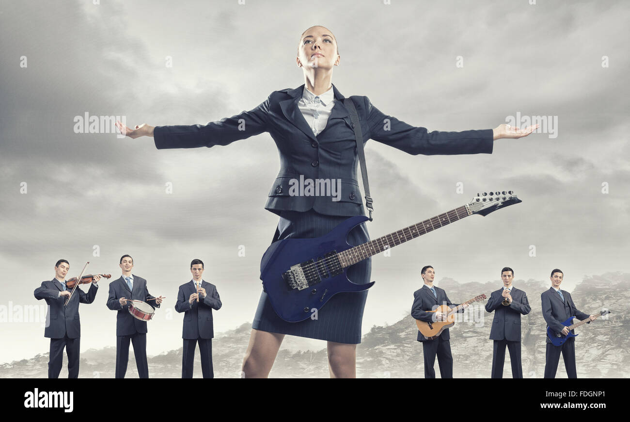 Man orchestra playing different music instruments and woman leader ...