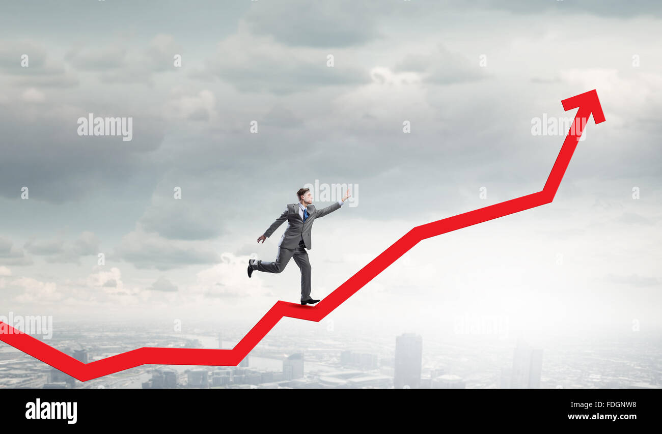 Young businessman running on increasing arrow graph Stock Photo - Alamy