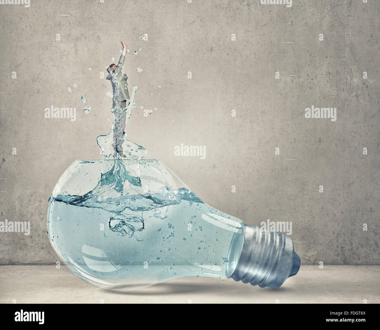 Glass light bulb filled with clear water and businessman inside Stock