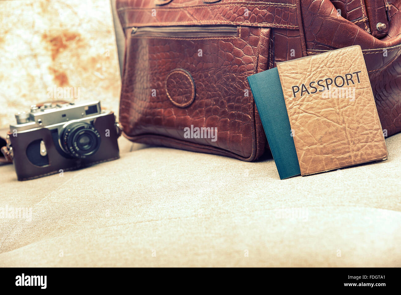 Bag and passport on the couch. Stock Photo