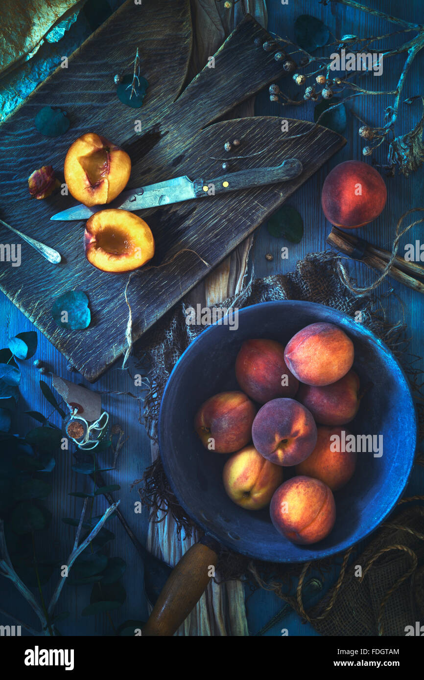 Fresh peaches on a rustic table. Stock Photo