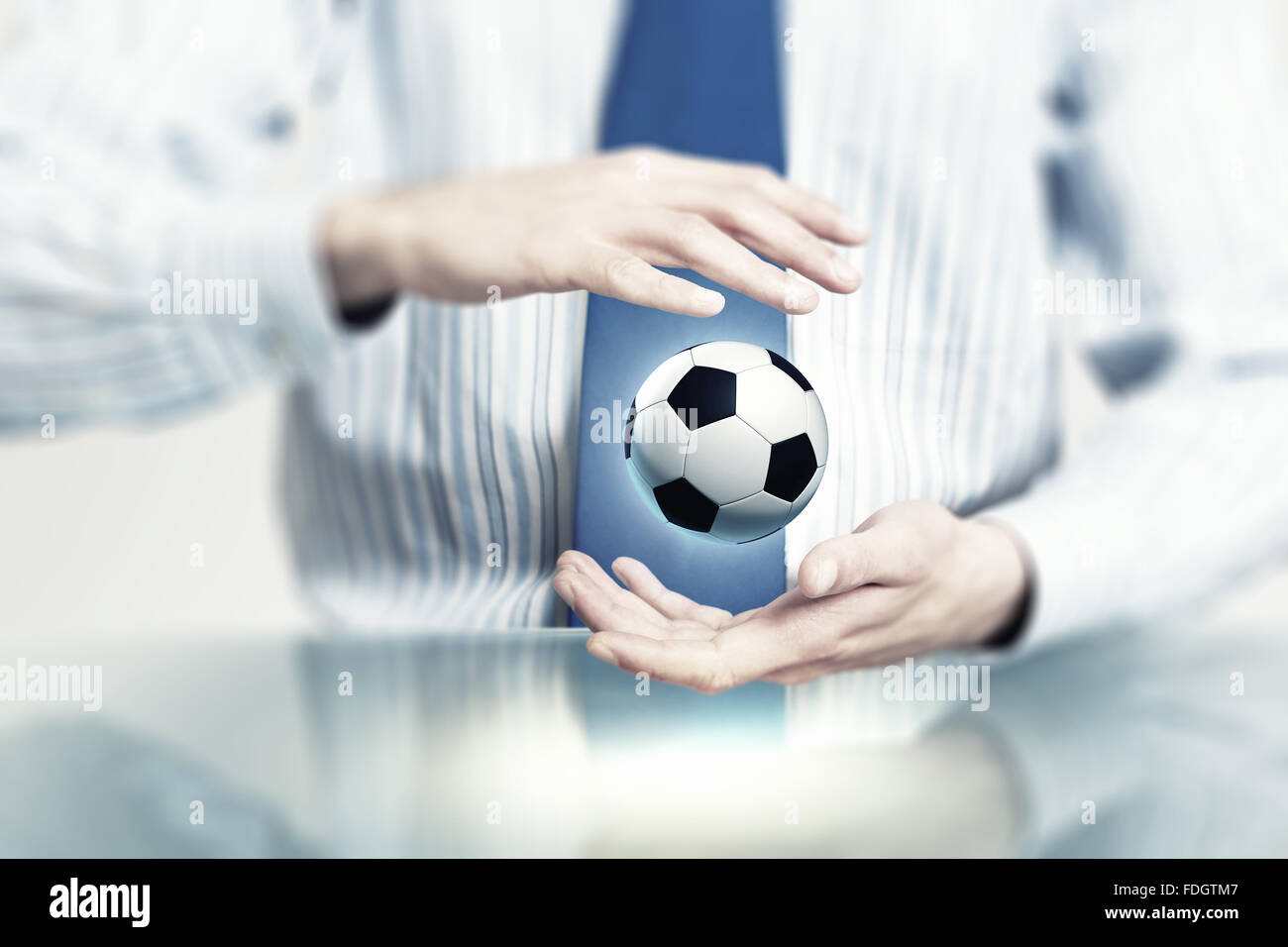 Hands of businessman holding with care soccer ball Stock Photo - Alamy