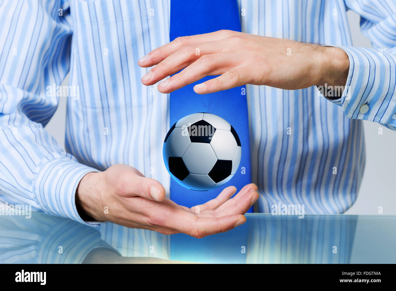 Hands of businessman holding with care soccer ball Stock Photo - Alamy