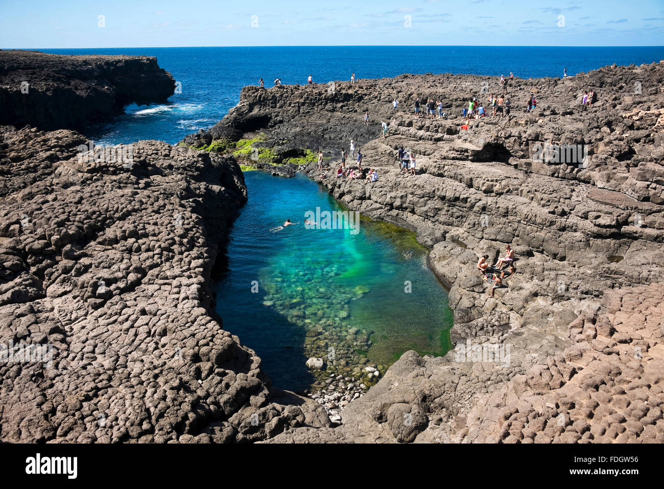 Horizontal view of tourists swimming in the lagoon at Olho Azul, the Blue Eye in Buracona. Stock Photo
