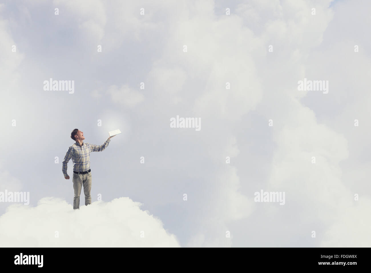 Young handsome man on sky background reaching hand with book Stock ...