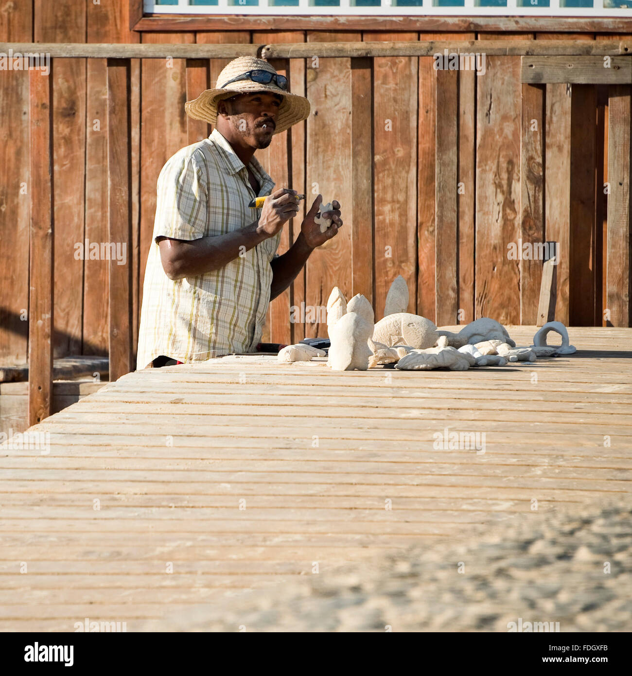 Square portrait of a local man carving turtle figures in Cape Verde. Stock Photo