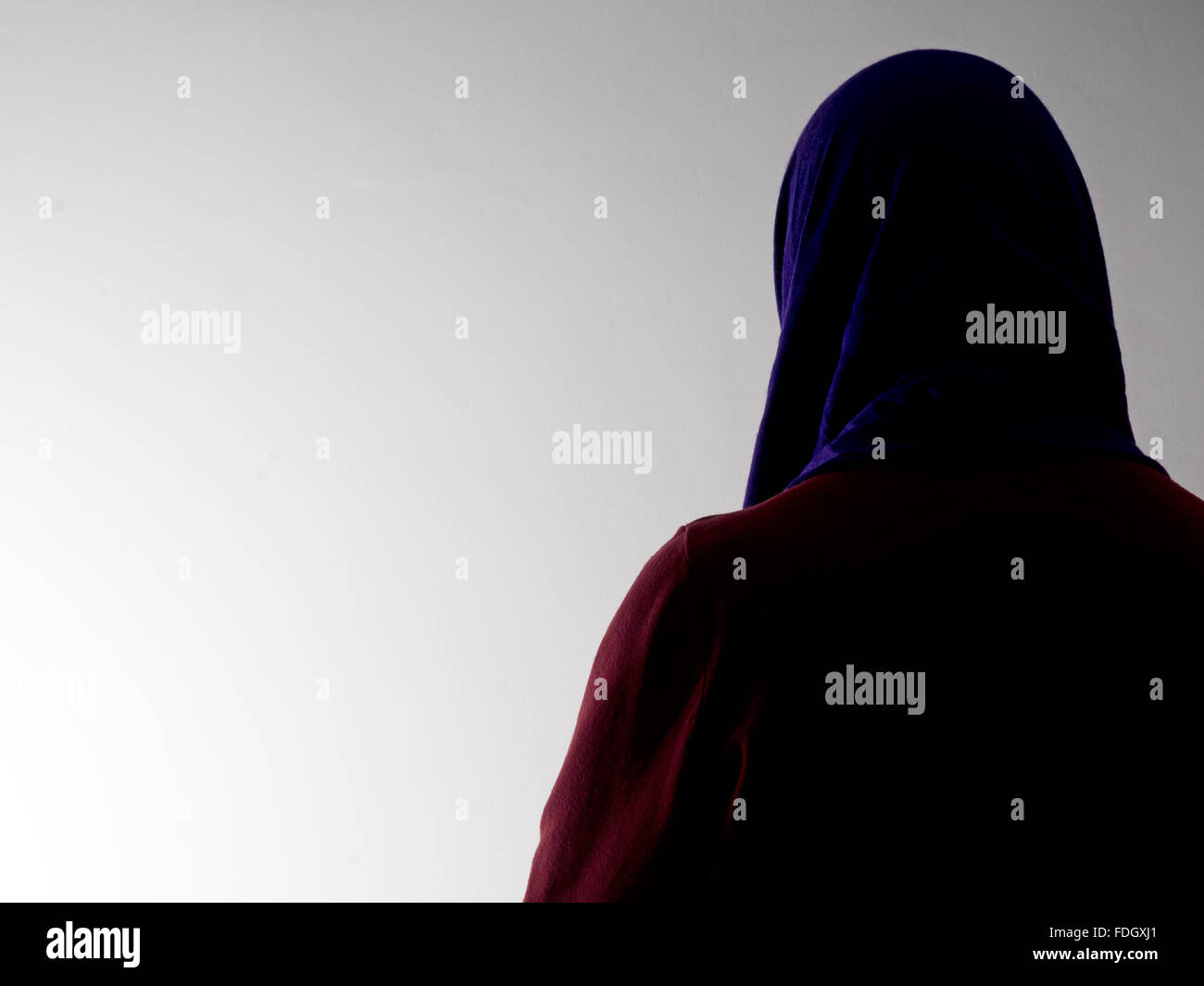 Woman seen from behind,disguised. Violence against women etc. Concept. Head covering. Stock Photo