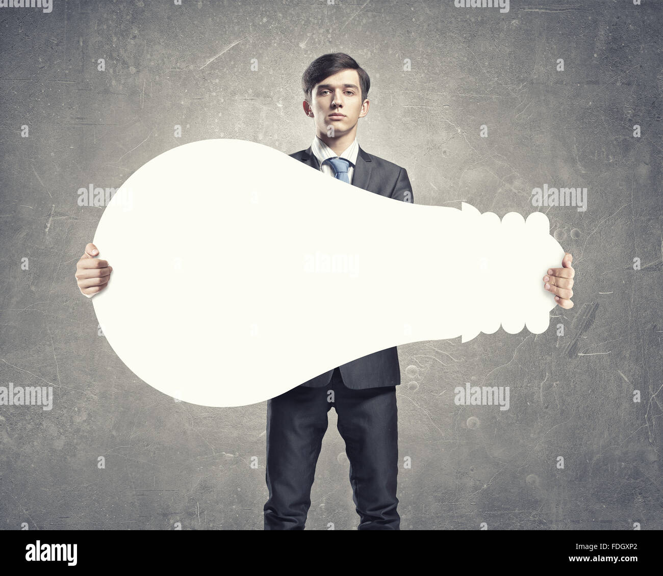 Young businessman holding light bulb paper concept Stock Photo - Alamy