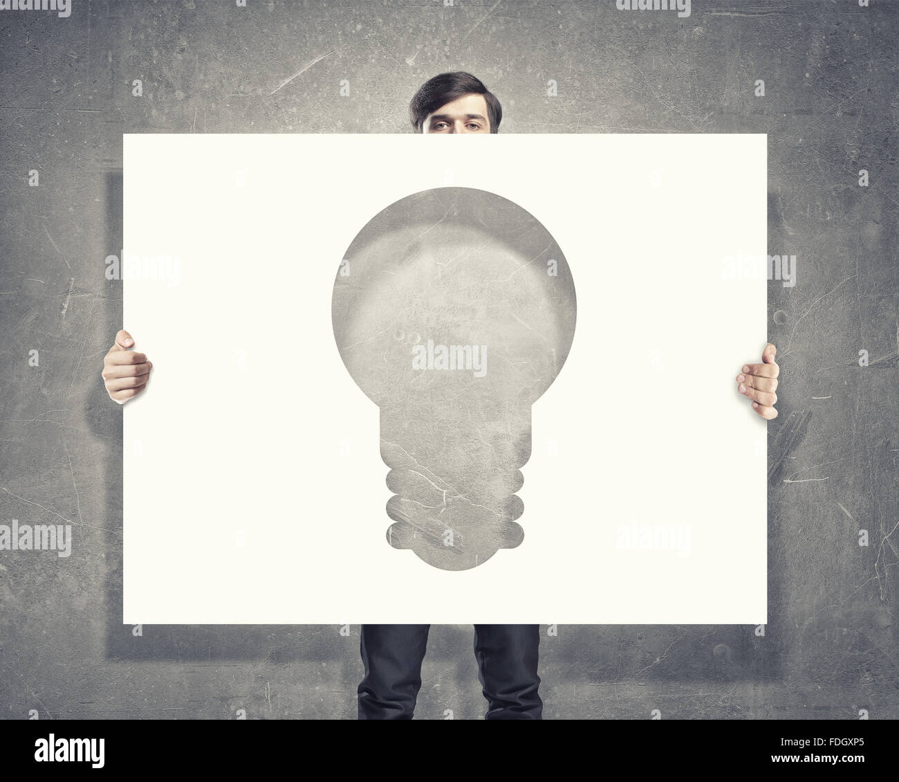 Young businessman holding light bulb paper concept Stock Photo - Alamy