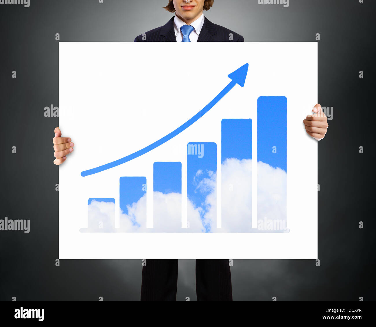 Businessman holding poster with growing arrow graph Stock Photo - Alamy