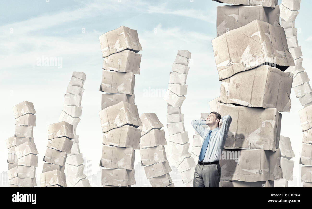 Man Stack Young businessman and stack of carton boxes behind him Stock Photo - Alamy