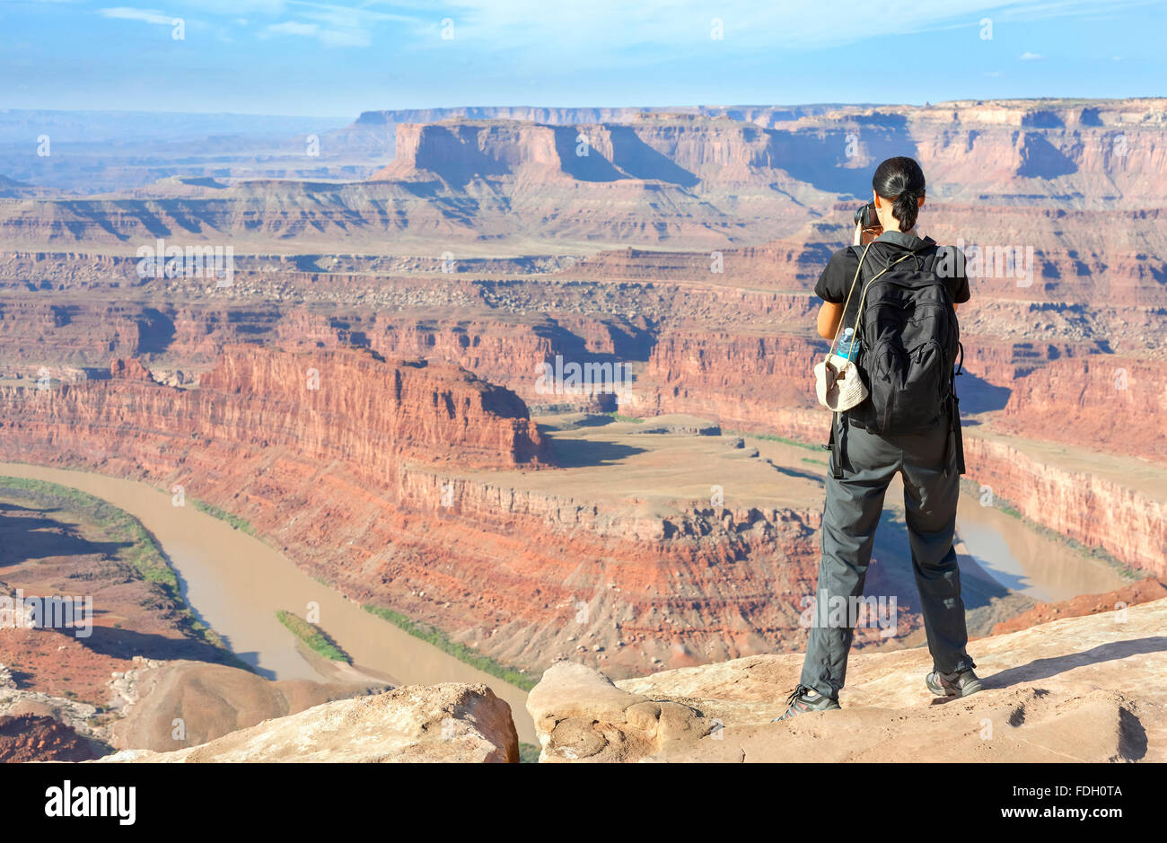 Female tourist taking pictures of a canyon landscape, USA. Stock Photo