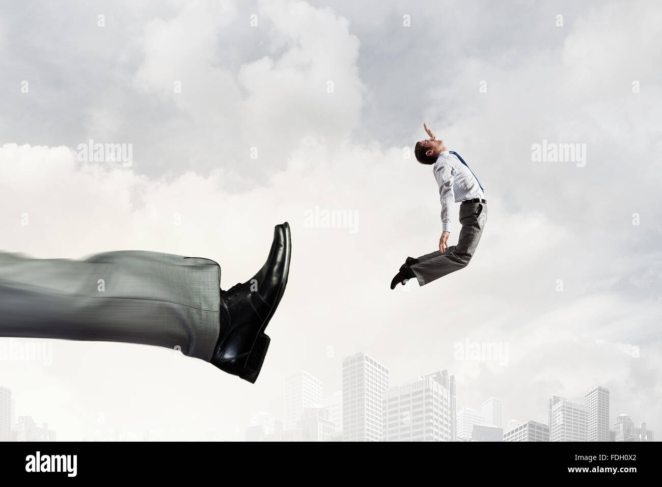 Businessman kicked by his boss big foot Stock Photo - Alamy