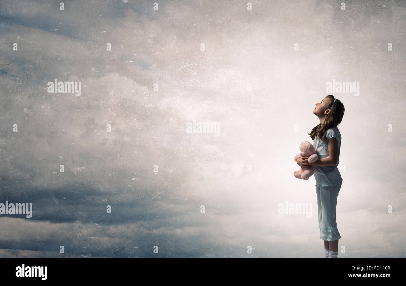 Cute girl wearing pajamas with toy bear in hand Stock Photo - Alamy