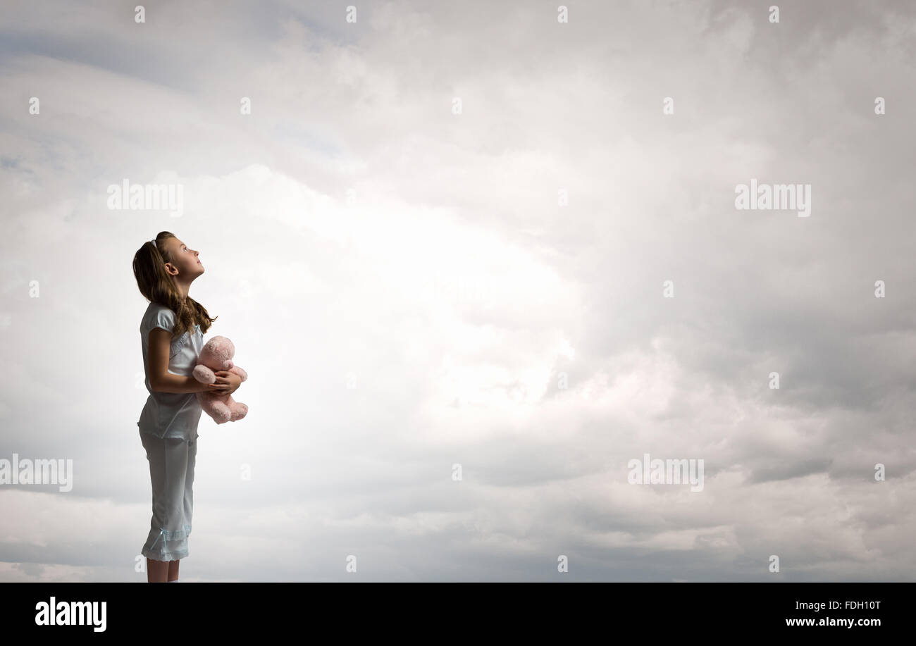 Cute girl wearing pajamas with toy bear in hand Stock Photo - Alamy