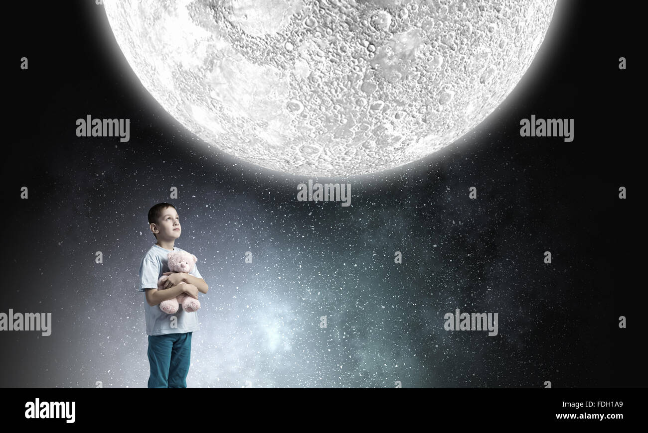 Cute little boy with toy bear in night darkness Stock Photo - Alamy