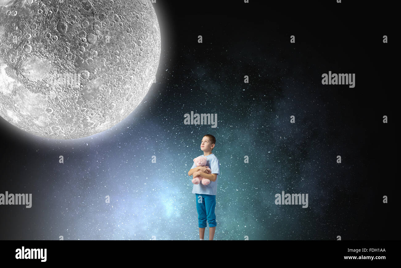 Cute little boy with toy bear in night darkness Stock Photo - Alamy