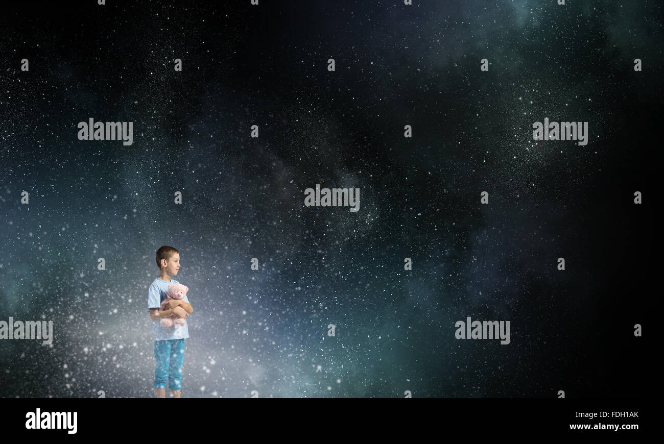 Cute little boy with toy bear in night darkness Stock Photo - Alamy