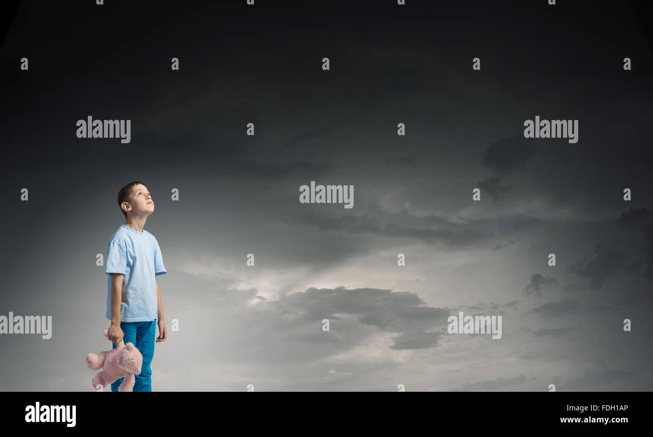 Cute little boy with toy bear in night darkness Stock Photo - Alamy