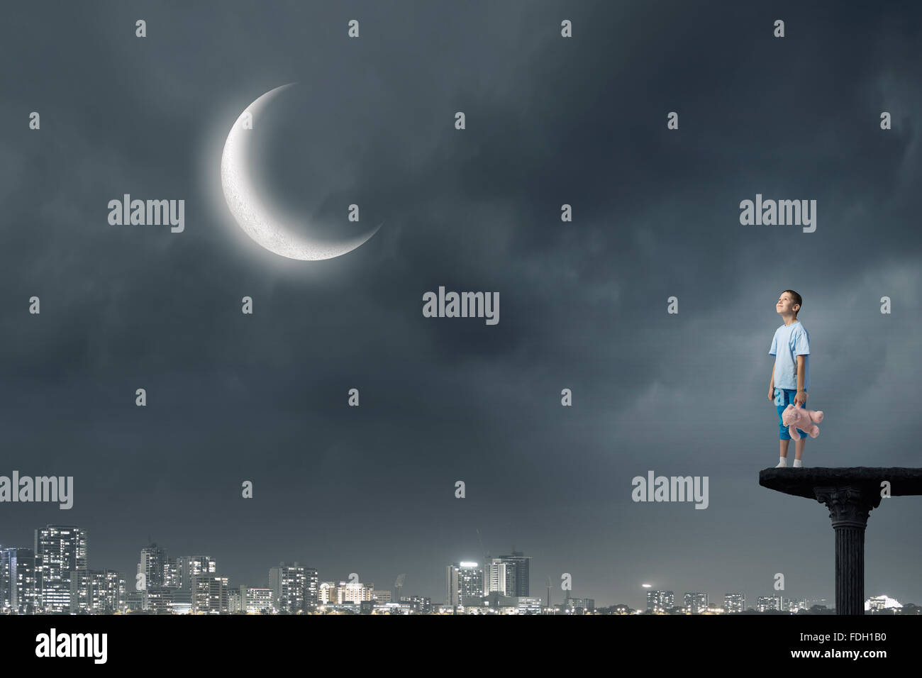 Cute little boy with toy bear in night darkness Stock Photo - Alamy