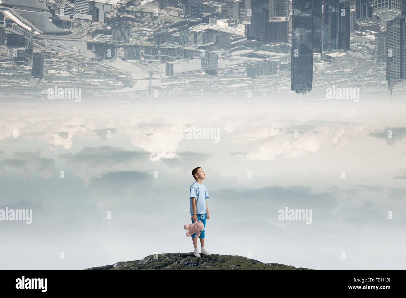 Cute little boy with toy bear on rock top Stock Photo - Alamy