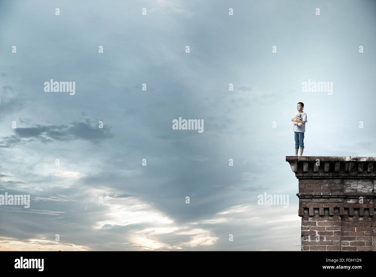 Cute little boy with toy bear on building top Stock Photo - Alamy