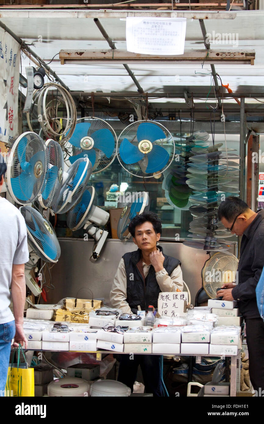 Chinese hawker selling electric appliances in Ap Liu Street, Hong Kong