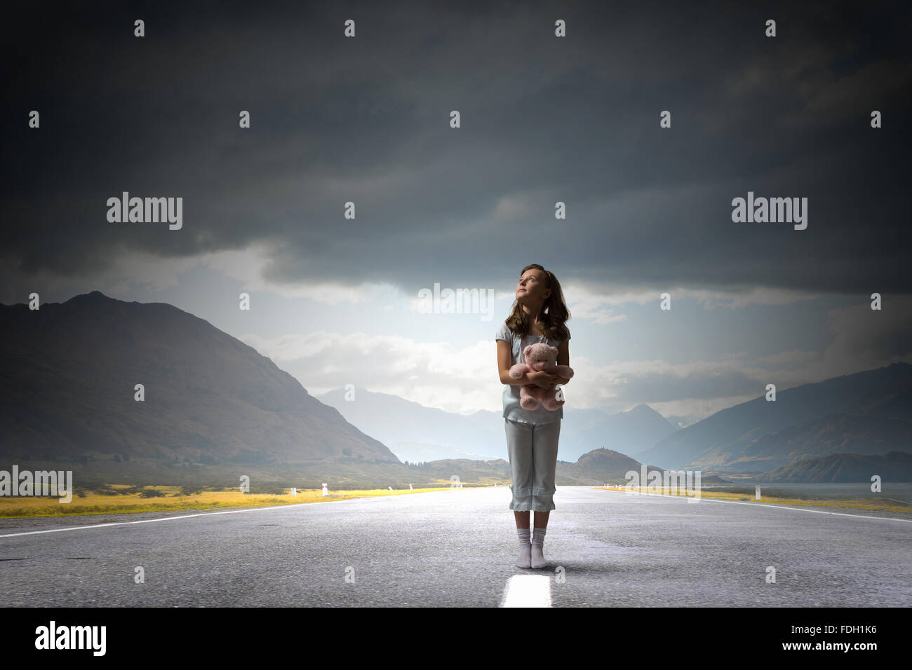 Cute girl wearing pajamas with toy bear in hand Stock Photo - Alamy