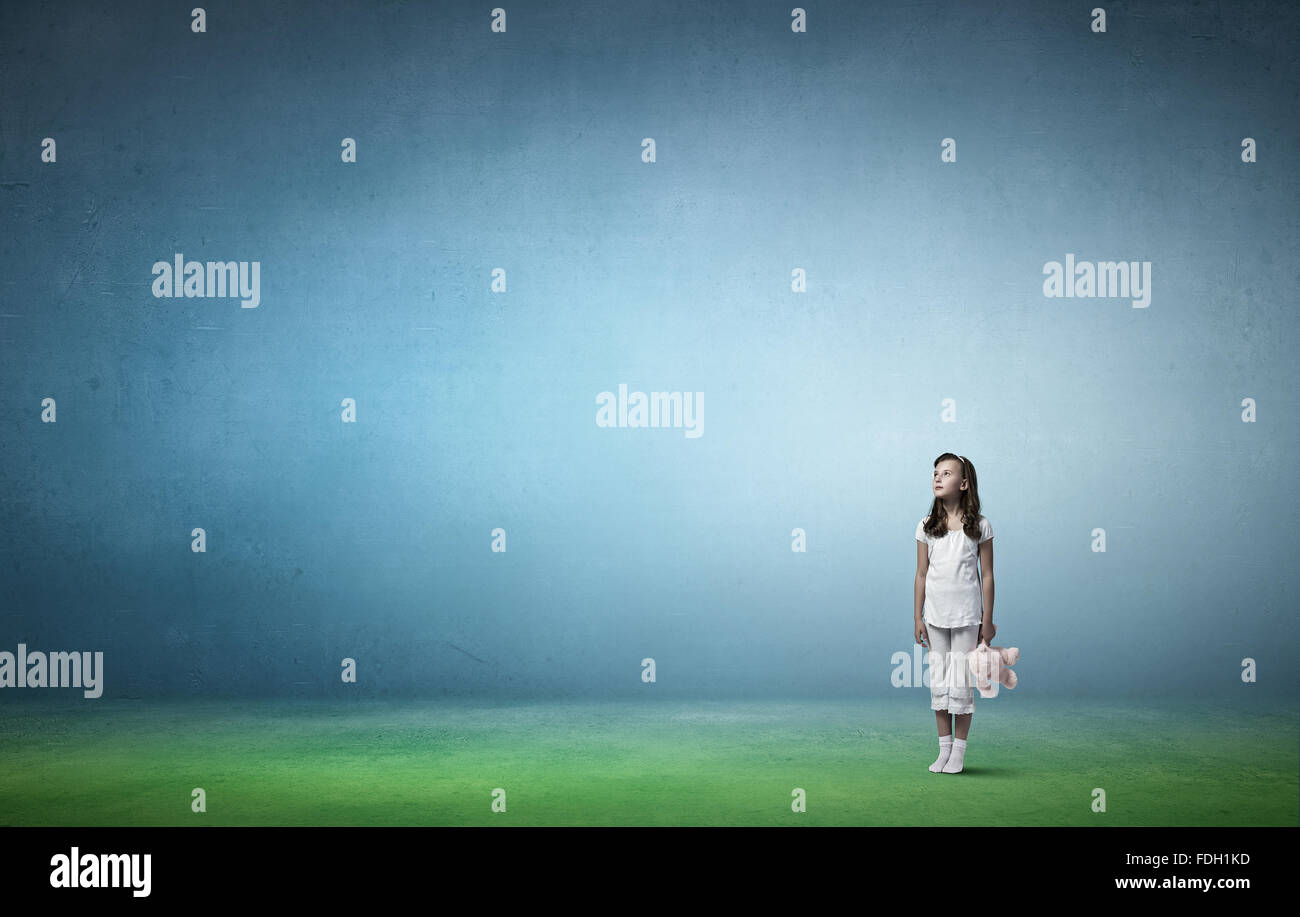 Cute girl wearing pajamas with toy bear in hand Stock Photo - Alamy