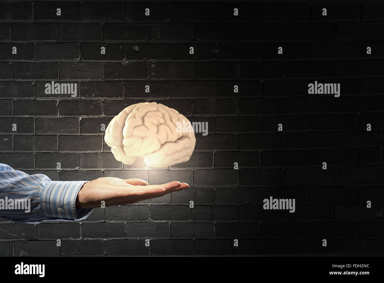Businessman holding image of human brain in palm Stock Photo - Alamy