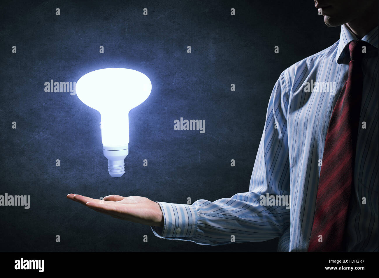 Businessman with illuminated glass light bulb in hand Stock Photo - Alamy