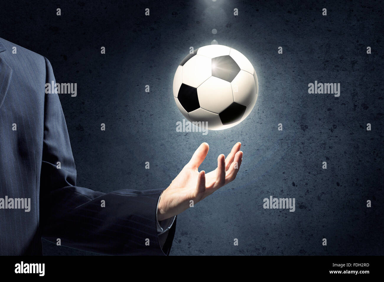 Close up of elegant businessman holding soccer ball in hand Stock Photo ...