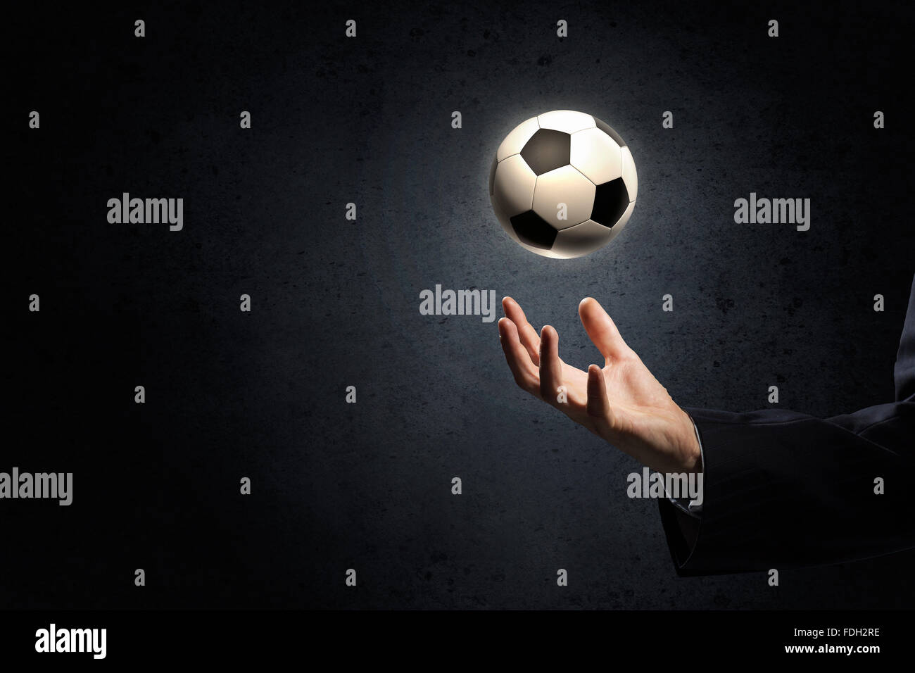 Close up of elegant businessman holding soccer ball in hand Stock Photo ...