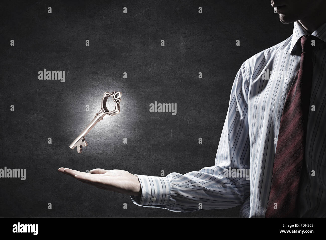Close up of businessman hand showing key to success Stock Photo - Alamy