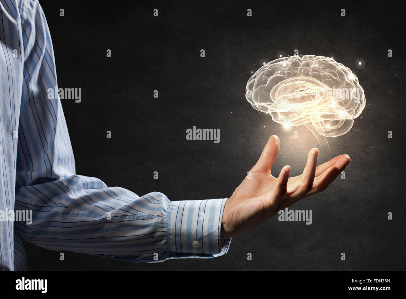 Close up of human hand holding brain symbiol Stock Photo - Alamy