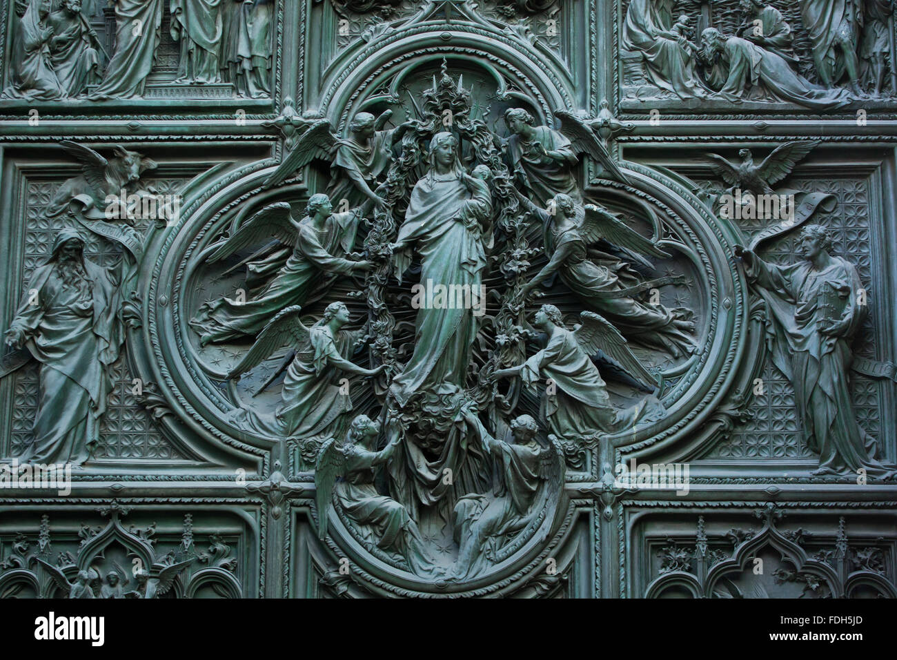 Assumption of the Virgin Mary. Detail of the main bronze door of the Milan Cathedral (Duomo di Milano) in Milan, Italy. Evangeli Stock Photo