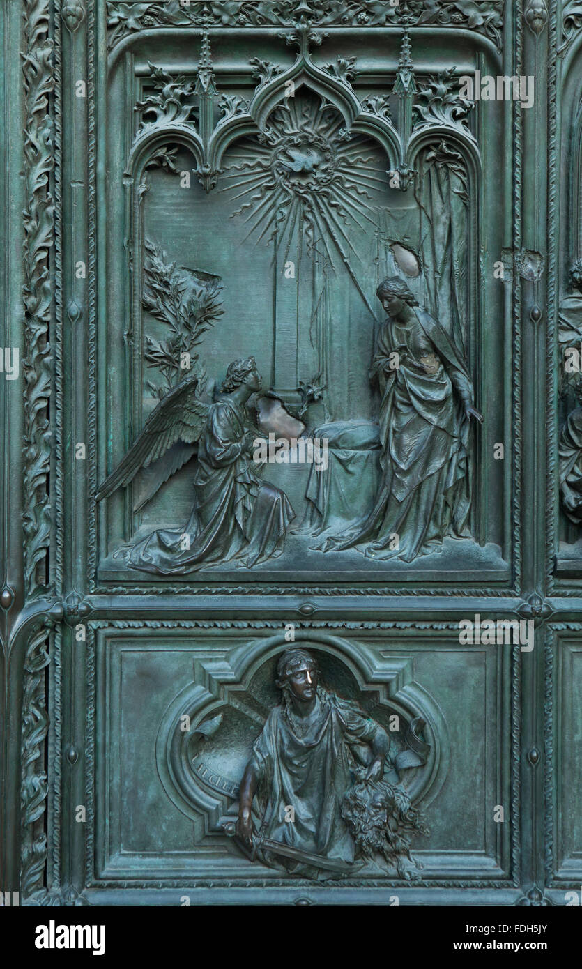 Annunciation. Detail of the main bronze door of the Milan Cathedral (Duomo di Milano) in Milan, Italy. The bronze door was desig Stock Photo