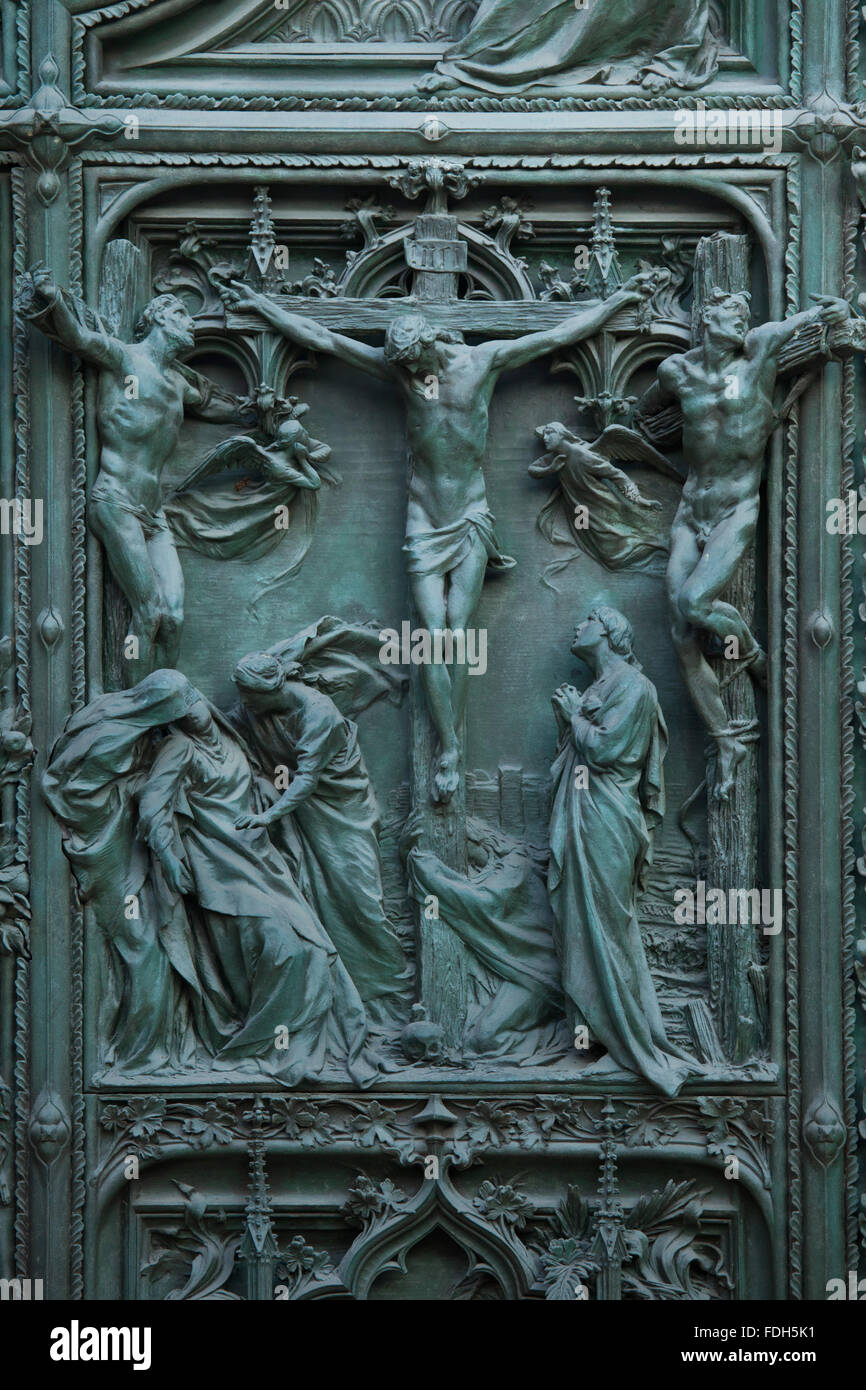 Crucifixion. Detail of the main bronze door of the Milan Cathedral (Duomo di Milano) in Milan, Italy. The bronze door was design Stock Photo