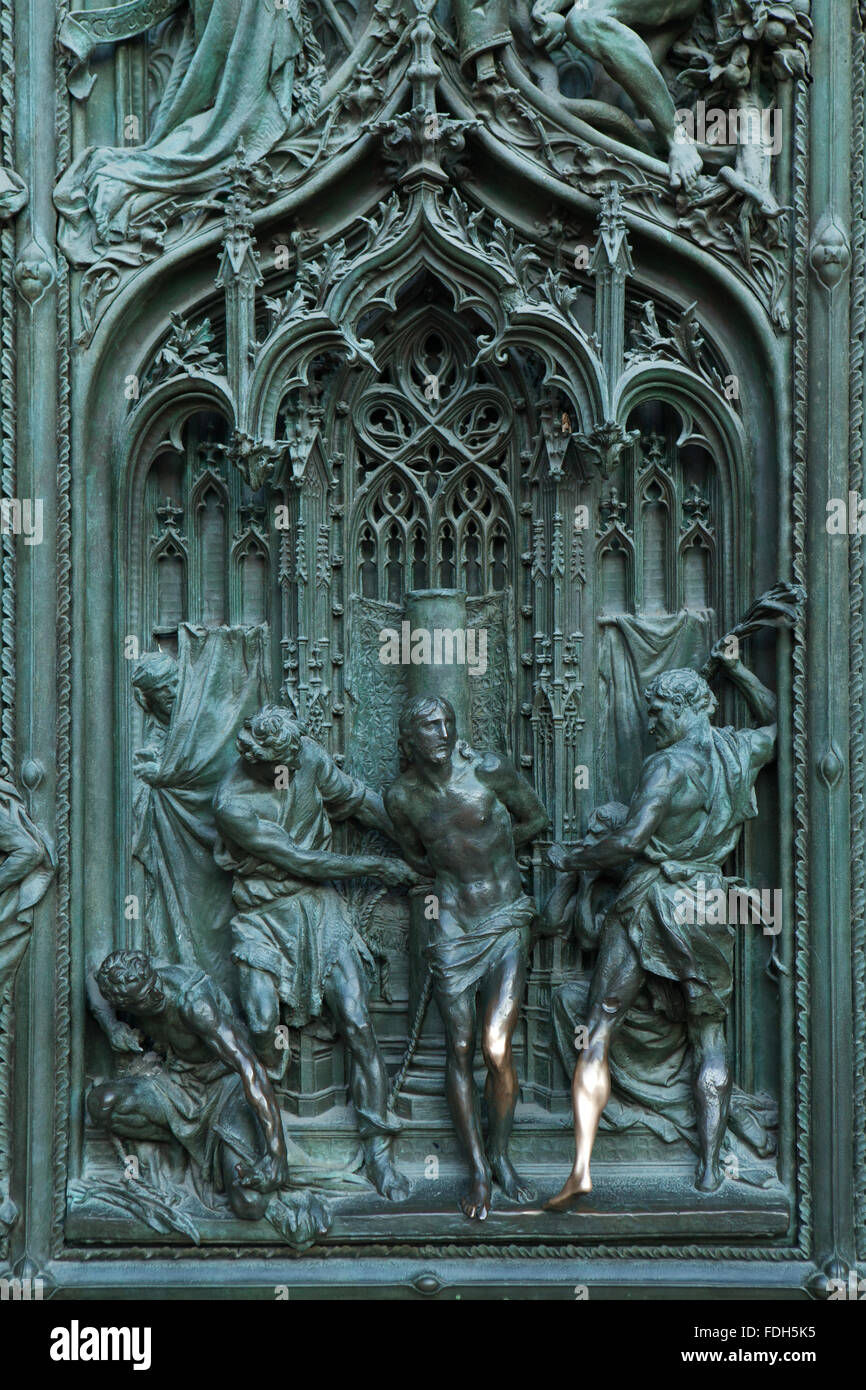 Flagellation of Christ. Detail of the main bronze door of the Milan Cathedral (Duomo di Milano) in Milan, Italy. Stock Photo