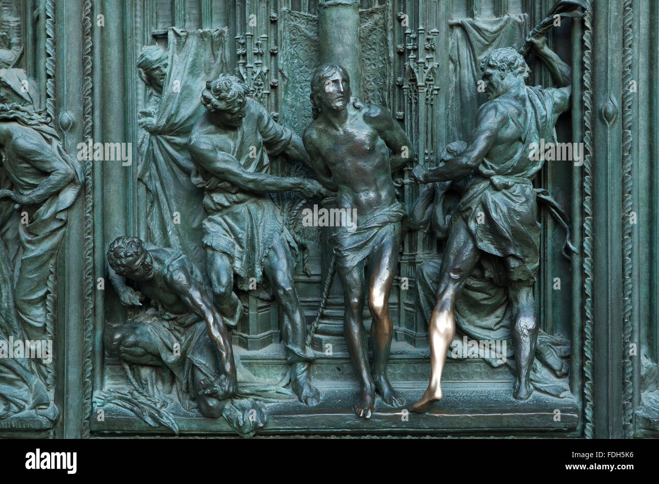 Flagellation of Christ. Detail of the main bronze door of the Milan Cathedral (Duomo di Milano) in Milan, Italy. The bronze door Stock Photo