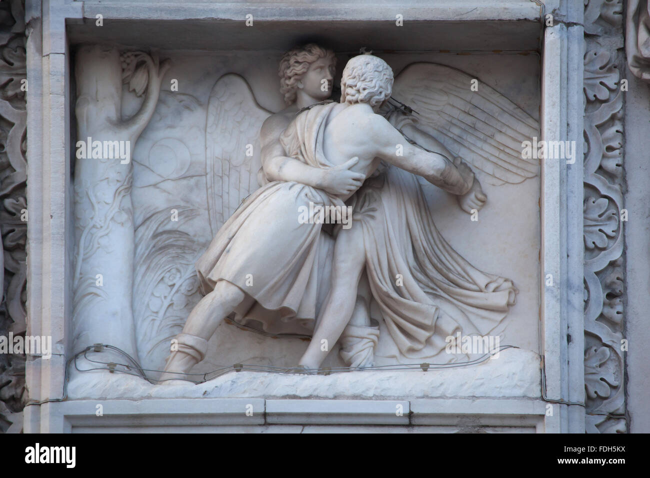 Jacob wrestling with the Angel. Marble relief on the south facade of the Milan Cathedral (Duomo di Milano) in Milan, Lombardy, I Stock Photo
