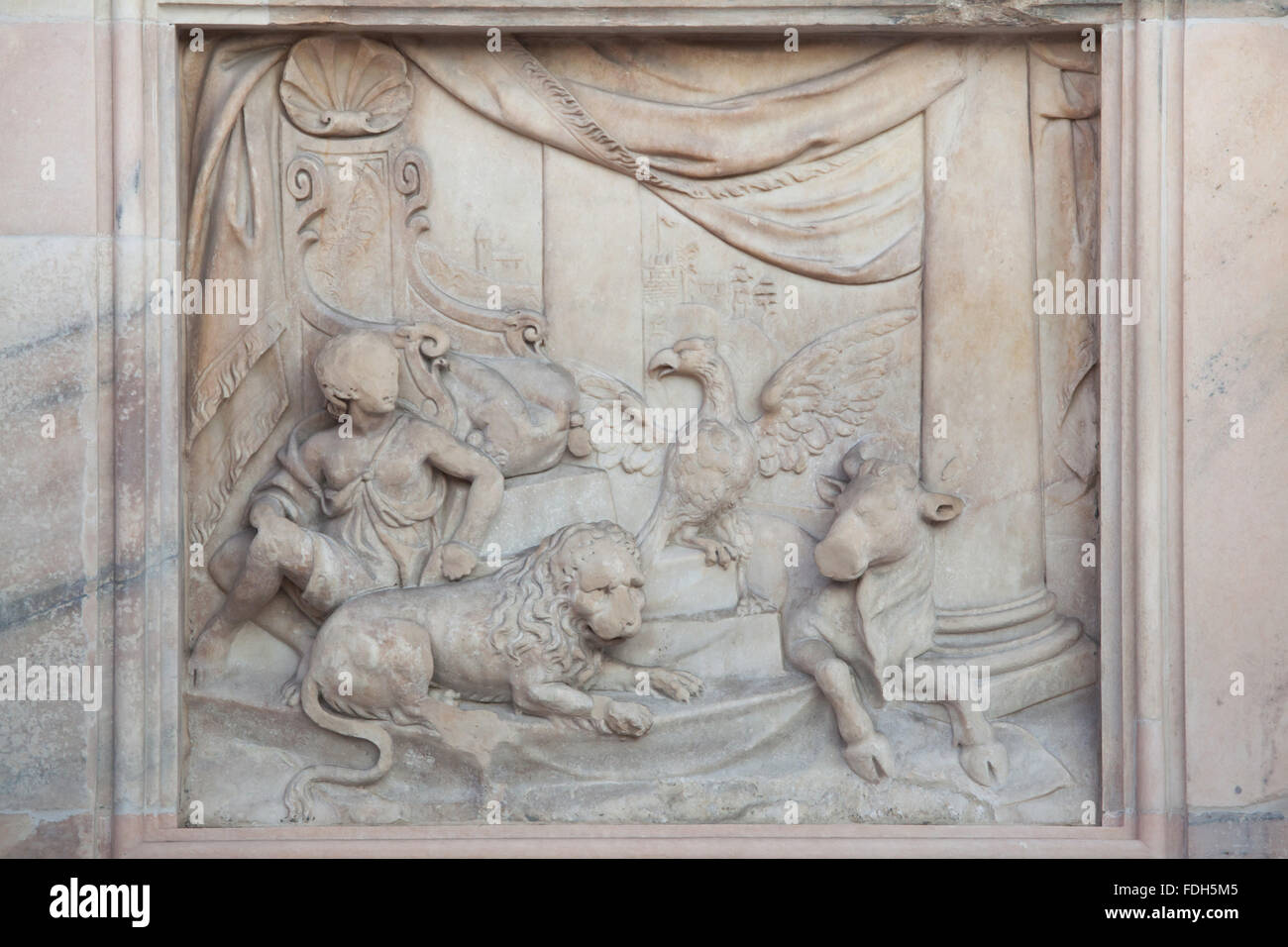 Throne of God and Four Living Creatures. Marble relief on the main facade of the Milan Cathedral (Duomo di Milano) in Milan, Lom Stock Photo