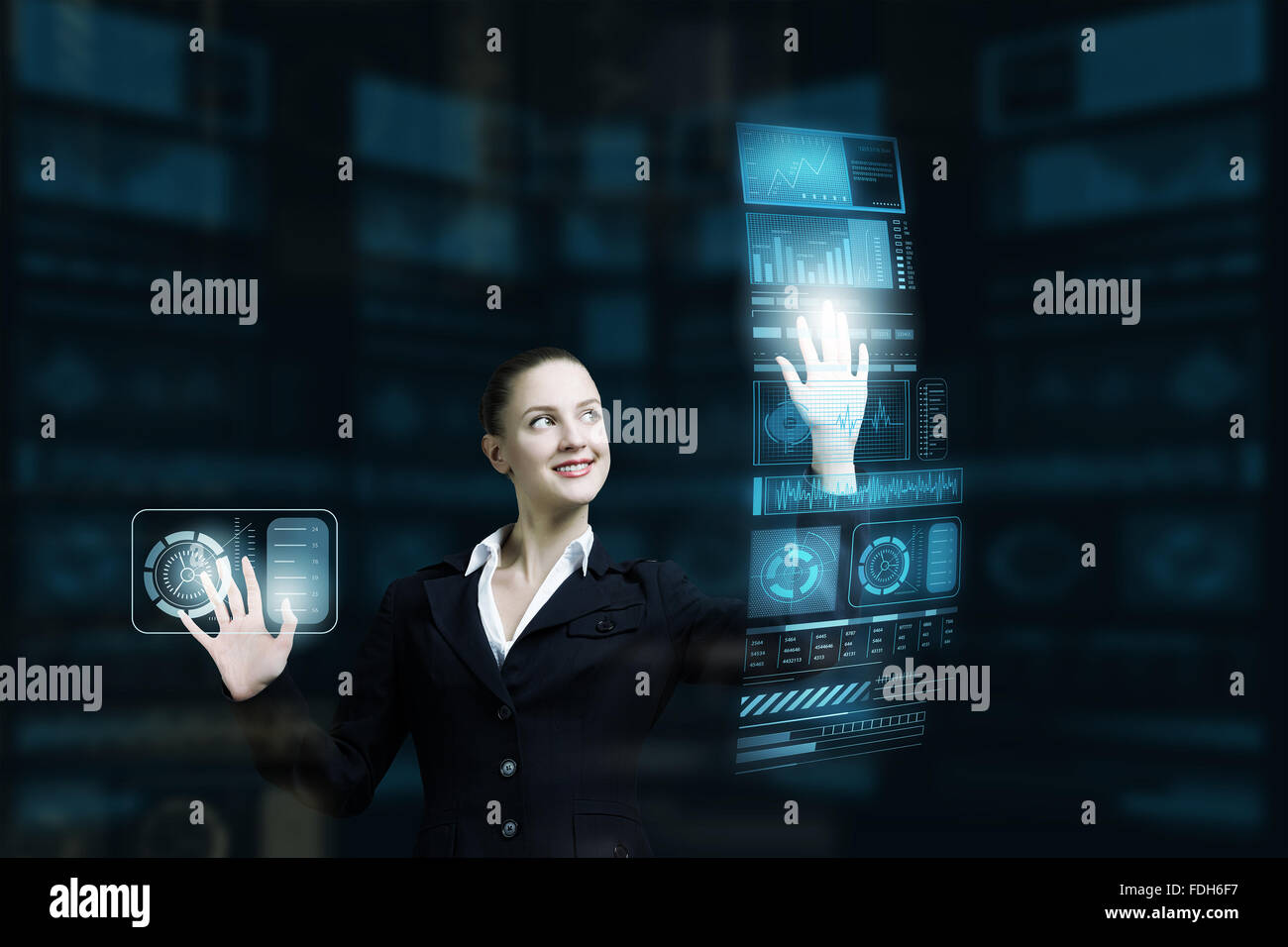Attractive smiling businesswoman working with virtual panel interface ...