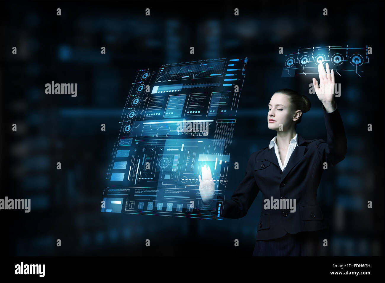 Attractive smiling businesswoman working with virtual panel interface ...
