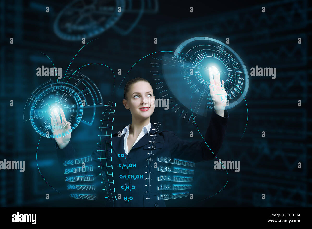 Attractive smiling businesswoman working with virtual panel interface ...