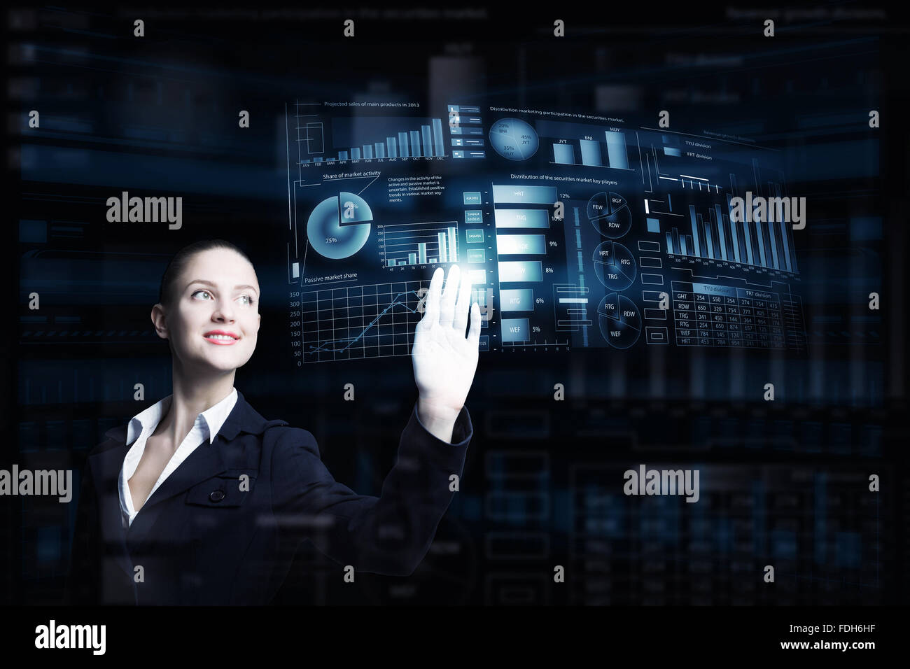 Attractive smiling businesswoman working with virtual panel interface ...