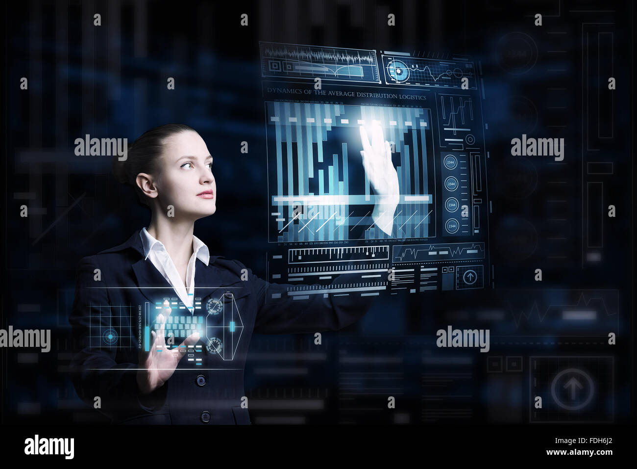 Attractive smiling businesswoman working with virtual panel interface ...