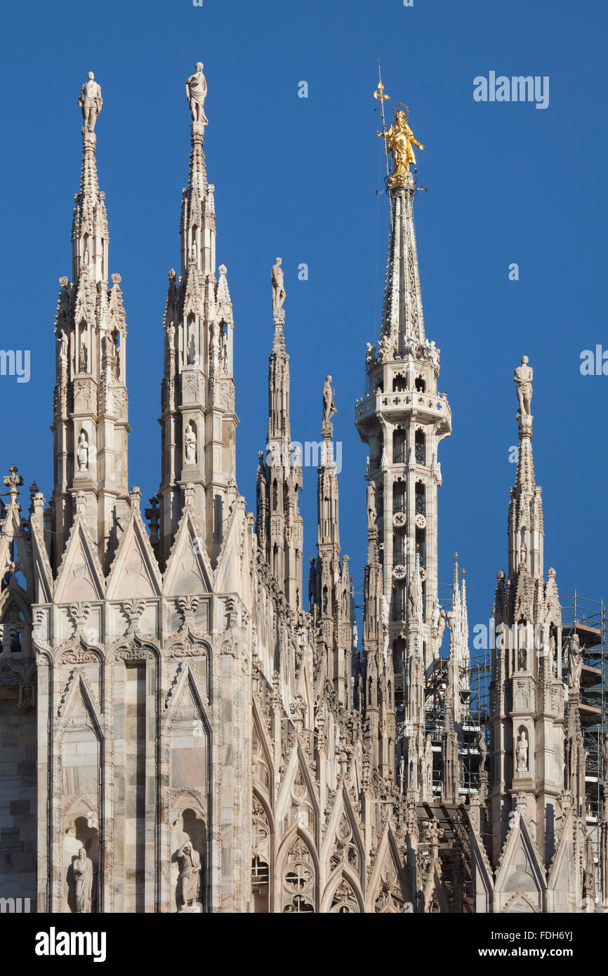 Gilded bronze statue of the Virgin Mary called the Madonnina on the spire of the Milan Cathedral in Milan, Lombardy, Italy. Stock Photo